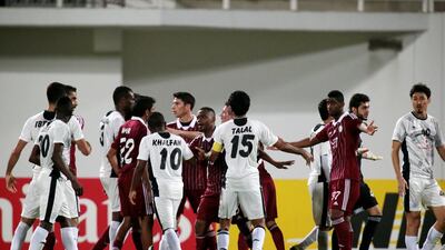 A scuffle broke out in the final minutes of regulation between Al Wahda, in red, and Al Sadd during their match in Abu Dhabi on Tuesday night. Three players were sent off. Christopher Pike / The National