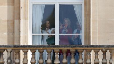 Guests including White House Press Secretary Sarah Sanders (L) watches from a balcony as the US President Donald Trump and US First Lady Melania Trump arrive for a welcome ceremony at Buckingham Palace. AFP