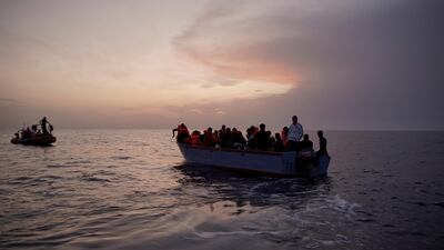 Migrants on an overcrowded wooden boat wait to be rescued in the Mediterranean Sea earlier this month. AP