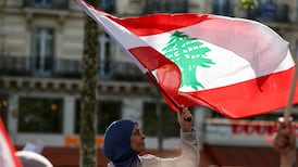 A protester waves a Lebanese flag at a rally in Paris. Further support for Lebanon’s armed forces and more help with the country’s humanitarian crisis would buttress talks in Washington. AFP