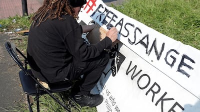 A protester writes a sign outside HMP Belmarsh prison in London where WikiLeaks founder Julian Assange is being held. Reuters