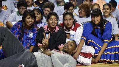 Dwight Howard of the Houston Rockets takes a photo with players from the Tarahumara women's basketball team during an NBA clinic in Mexico City on Tuesday. Yuri Cortez / AFP