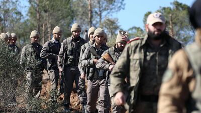Turkish-backed Syrian rebels march on Mount Barsaya north of Azaz, on January 29, 2018, as the Turkish offensive against Kurdish forces in the Syrian border region of Afrin continues. Nazeer Al Khatib / AFP