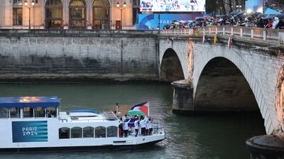 Team Palestine waves their flag along the River Seine during the opening ceremony of the Olympic Games Paris 2024 on July 26, in Paris. Getty Images