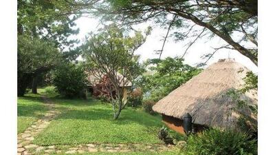 Ndali Lodge's six thatched cottages are dotted along a steep ridge beside a lake.
