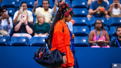 Naomi Osaka sparkled under the lights of Arther Ashe Stadium in a jacket decorated in crystals and rhinestones and her hair in a ponytail of sparking red roses. Getty Images