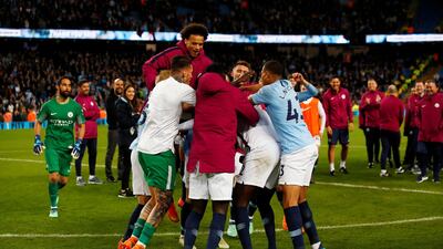 The Manchester City squad hug Yaya Toure during a ceremony after the match. Jason Cairnduff / Reuters