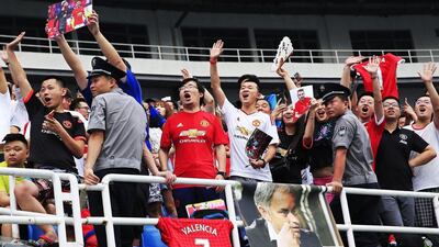 Chinese fans of Manchester United cheer during a training session of the Premier League side at the Olympic Sports Center in Beijing, China, 24 July 2016. How Hwee Young / EPA