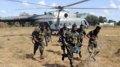 Government soldiers run across a field at Palampeddi village in north western Mannar, July 4, 2008. Sri Lanka beefed up security on Monday and warned of possible rebel attacks around the capital Colombo as the island's Tamil Tiger rebels marked the 21st anniversary of their first rebel suicide attack.