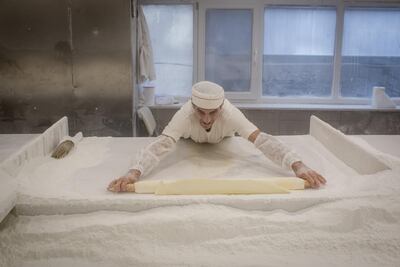 A baker rolls pastry for a batch of Baklava with precision. Getty