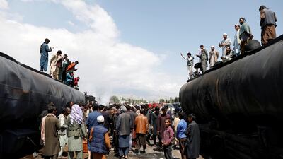 People stand near the coffin of a victim after an overnight fire. Reuters