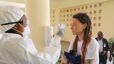 Canadian Edith Blais, who was released after being kidnapped by extremists while travelling in Burkina Faso, has her temperature taken due to coronavirus preventive measures. MINUSMA, HO