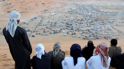 Spectators look down on the main camp - a sea of 4x4 vehicles and exhibition tents in the distance. Victor Besa / The National