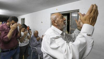 Members of the Ashour family gather in prayer at a family home, due to closure of mosques during the coronavirus pandemic, in the flashpoint city of Hebron in the occupied West Bank to mark Lailat al-Qadr, a night in the holy month of Ramadan during which the Koran was first revealed to the Prophet Mohammed in the seventh century. AFP