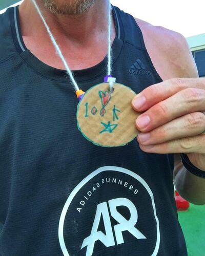 Dubai runner Lee Ryan with a medal made by daughter, Lily. Courtesy Lee Ryan