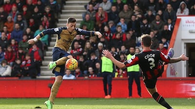 Mesut Ozil scores the first goal for Arsenal. Action Images via Reuters / Matthew Childs