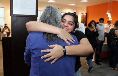 Drishtee Johar gets a hug from her principal, Nargish Khambatta, for her IB results at Gems Modern Academy, Nad Al Sheba, Dubai. Pawan Singh / The National