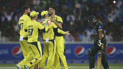 Mitchell Johnson of Australia celebrates with teammates after dismissing Shahid Afridi of Pakistan during the second match of the one day international series between Australia and Pakistan at Dubai Sports City Cricket Stadium on October 10, 2014 in Dubai, United Arab Emirates. Francois Nel/Getty Images