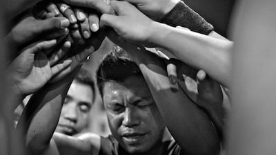 Benji Bogal, Captain of the Black team leads a prayer during half-time of a game.