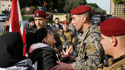 Army soldiers scuffle with anti-government protesters blocking a road leading to the parliament building in Beirut. AP