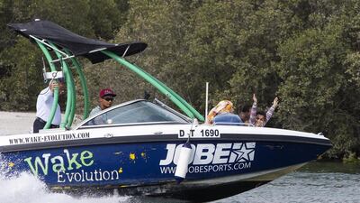 A girl waves from a boat while riding past Mangroves National park in Abu Dhabi. Christopher Pike / The National