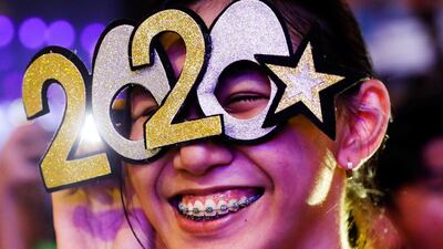 A reveller wears glasses shaped like the year 2020 during the New Year's Eve party in Quezon City, Metro Manila, Philippines. Reuters