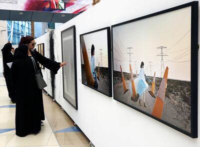 Visitors at the UAE Women in Art exhibition at the Zayed University in Dubai. Satish Kumar for The National
