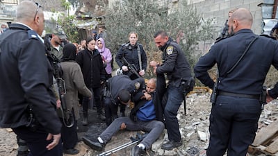 Israeli police officers detain a Palestinian during a protest supporting Palestinian families who are under threat of eviction from their longtime homes by Jewish settlers in the east Jerusalem neighbourhood of Sheikh Jarrah last December. AP Photo