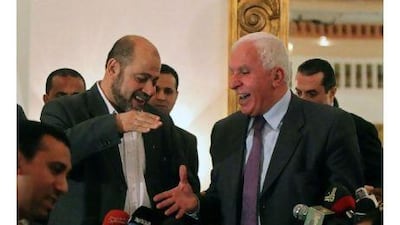 Fatah delegation chief Azzam al Ahmed, right, shares a laugh with Hamas deputy leader Mussa Abu Marzug. A reader hails their historic accord in Cairo. Khalid Desooki / AFP