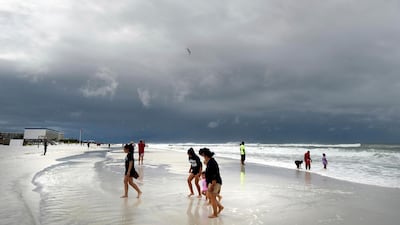 Beachgoers walk on Okaloosa Island in Fort Walton Beach, Florida as subtropical storm Alberto approaches the US Gulf Coast. Nick Tomecek / Northwest Florida Daily News via AP