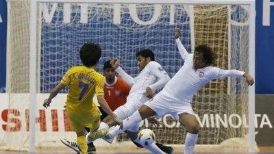 Thailand's Wongkaeo Kritsada shoots on goal as UAE defenders try to block his shot. Thailand defeated the UAE 4-2 to advance to the knock-out stages of the AFC Futsal Championship in Dubai.