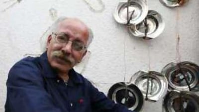 The Emirati artist Hassan Sharif with some of his work at The Flying House in Dubai.