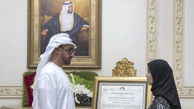 Sheikh Mohammed bin Zayed receives a gift on the occasion of Emirati Women's Day from Dr Amal Abdullah Al Qubaisi, Speaker of the Federal National Council.Mohamed Al Hammadi / Crown Prince Court - Abu Dhabi