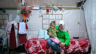 Earthquake survivors Kubra Goknar and her daughter Leyla in their tent in Kahramanmaras, south-eastern Turkey. AP