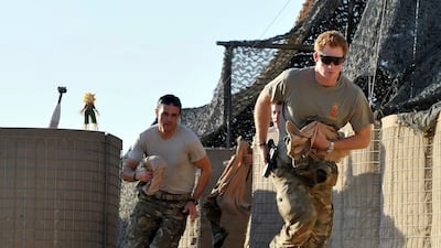 Prince Harry and fellow pilots race from their tents to scramble their Apaches. AP