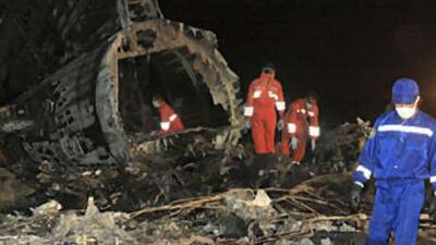 Rescuers and investigators work at the crash site of a Boeing 737 passenger jet, just outside Manas International Airport near the Kyrgyz capital Bishkek early on Aug 25 2008.