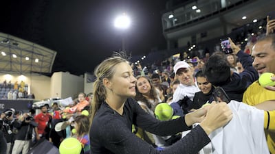 Maria Sharapova signs autographs after her win over Ajla Tomljanovic at the Mubadala World Tennis Championship. Chris Whiteoak / The National