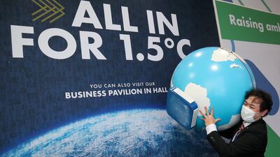 A model of the globe is carried through the venue in Glasgow. Reuters
