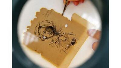 A scientist works on part of a travel book note of Cesare Pasquarella, dated 1200.