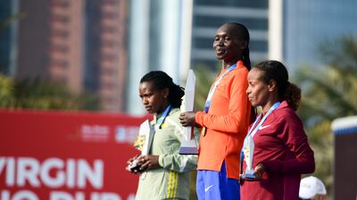 From left: Angela Tanui, who finished second, race winner Eunice Chumba and Mare Dibaba on the podium for women's elite category at the Adnoc Abu Dhabi Marathon.