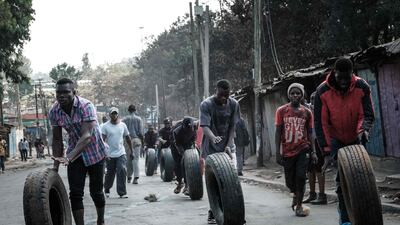 Protesters roll tyres towards a barricade in the Kibera neighbourhood of Nairobi, where supporters of Kenya’s opposition leader Raila Odinga have again clashed with police. AFP
