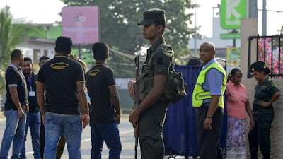 A Sri Lankan Army soldier stands guard outside the St. Theresa's church as the Catholic churches hold services again after the Easter attacks in Colombo on May 12, 2019. Thousands of Catholics attended mass in Sri Lanka's capital Colombo on May 12 amid tight security to prevent a repeat of Easter bomb attacks that killed 258 people. / AFP / LAKRUWAN WANNIARACHCHI