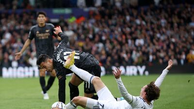 Arsenal's Gabriel Martinelli is challenged by Brenden Aaronson. Getty