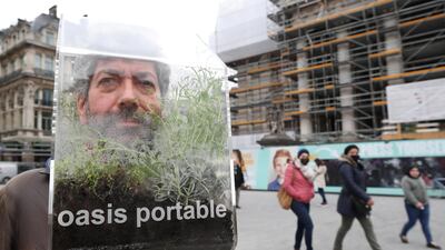 Belgian artist Alain Verschueren wears his "Portable Oasis" while performing in a street, saying he wanted to be in his bubble in the middle of the city, in Brussels, Belgium. Reuters