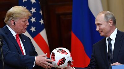 US President Donald Trump received a football from his Russian counterpart in Helsinki. AFP