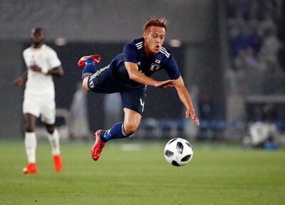 Japan midfielder Keisuke Honda falls after colliding with Ghana defender Andrew Kyere-Yiadom (not pictured) during a recent friendly. Franck Robichon / EPA