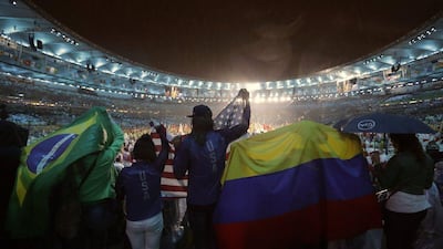People wave flags from Brazil, the United States, and Colombia during the Closing Ceremony for the Rio Olympics inside Maracana stadium in Rio de Janeiro, Brazil on Sunday. Jae C Hong / AP Photo