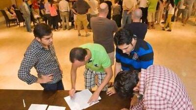 Victims of the Shamyana subletting scam sign a letter addressed to the Ruler of Dubai.