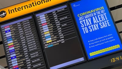A public health campaign message is displayed on an arrivals information board at Heathrow Airport, following the outbreak of the coronavirus disease (COVID-19), London, Britain, July 29, 2020. REUTERS/Toby Melville