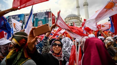 People attend a speech of Turkish President Recep Tayip Erdogan one day before the elections in Istanbul, Turkey, on June 23, 2018. Aris Messinis / AFP